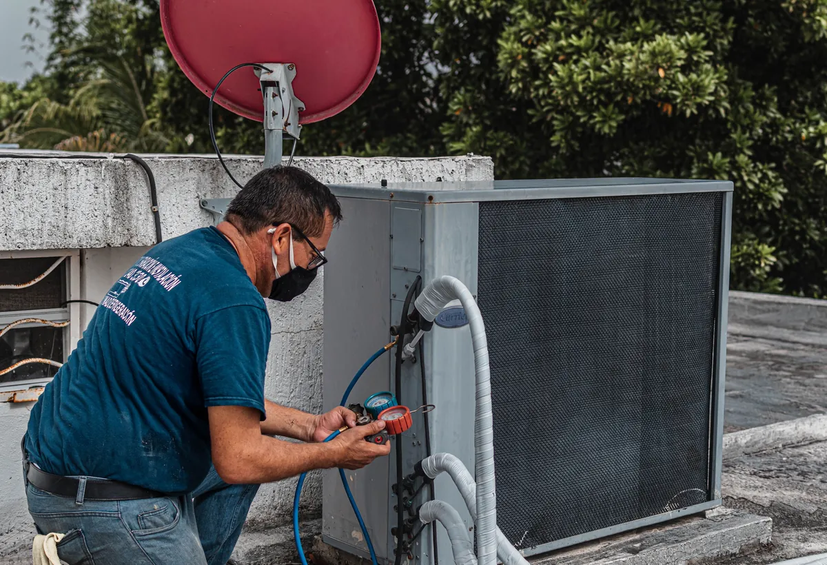 HVAC technician evaluating outdoor equipment