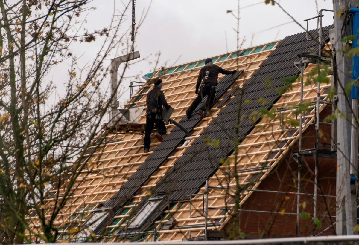 Roofing crew completing a residential replacement